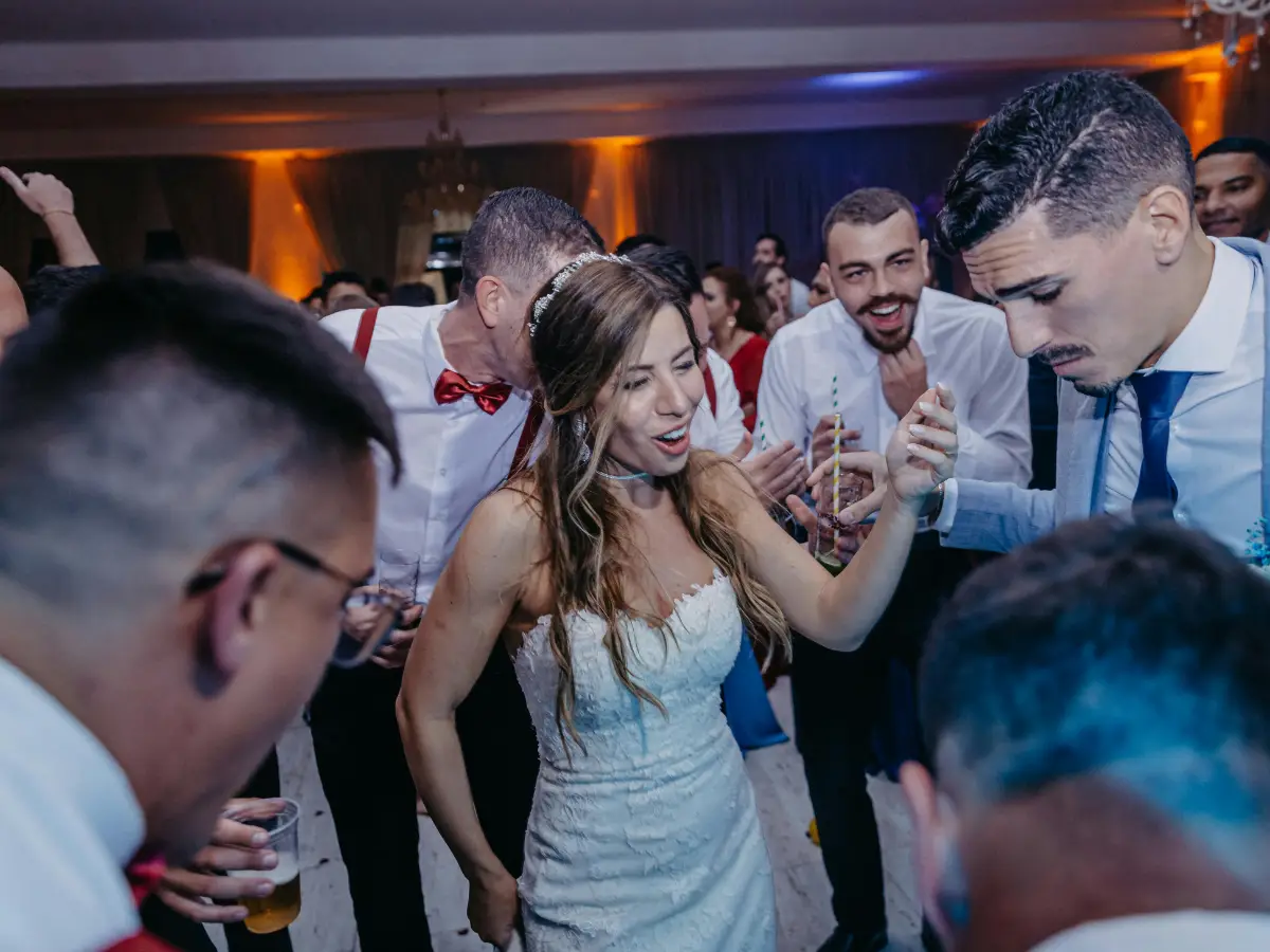Wedding reception dance floor with guests enjoying drinks and celebration