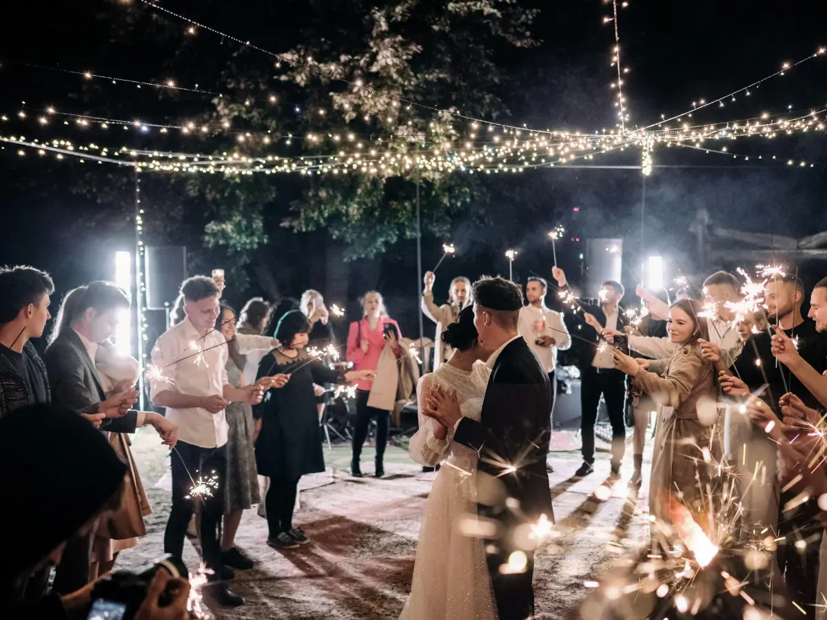 Magical wedding reception at night with sparklers and dancing guests